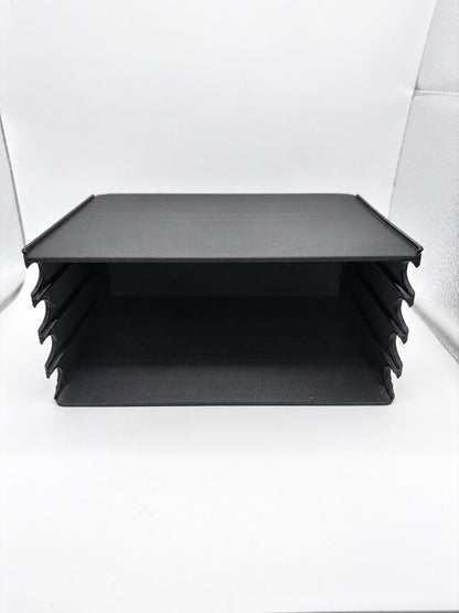 Close-up of the empty black holder showing four horizontal lanes and front finger scoops.