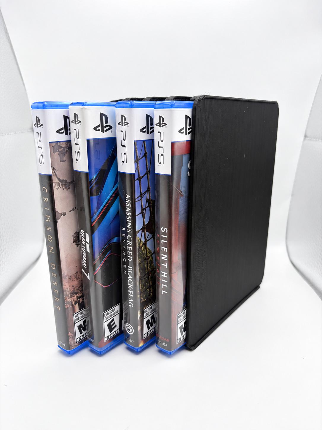 The same four-case holder turned vertically, showing four upright PS5 cases and the black side panel.