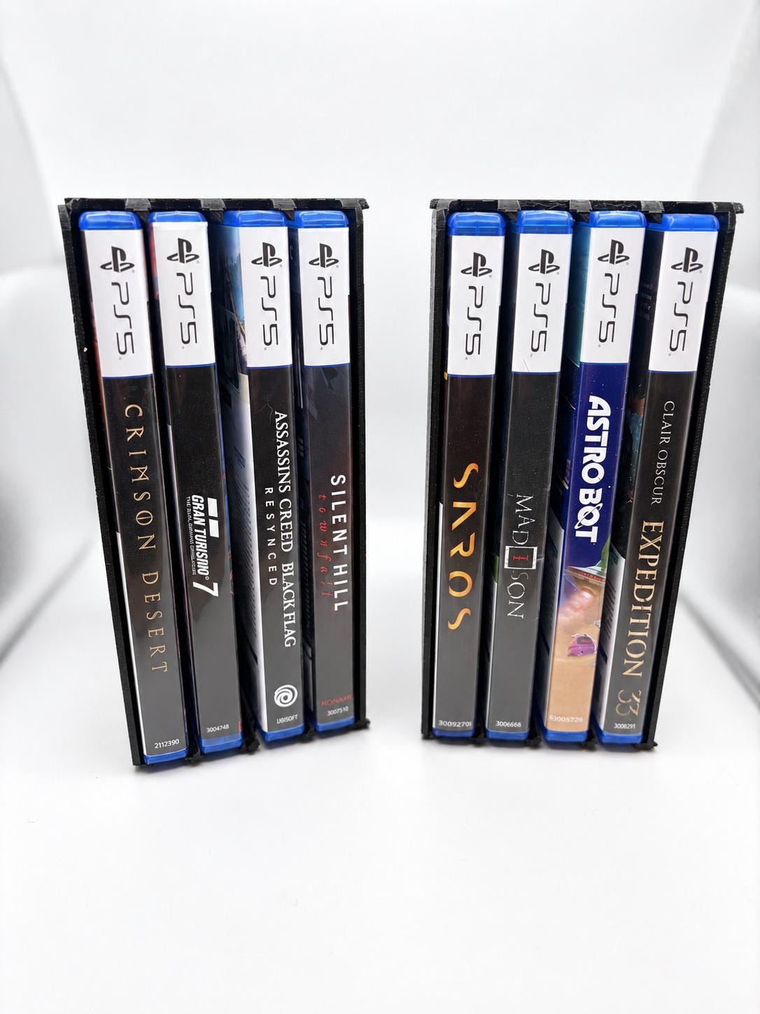 Two black four-case holders placed side by side vertically, with eight cases in total.