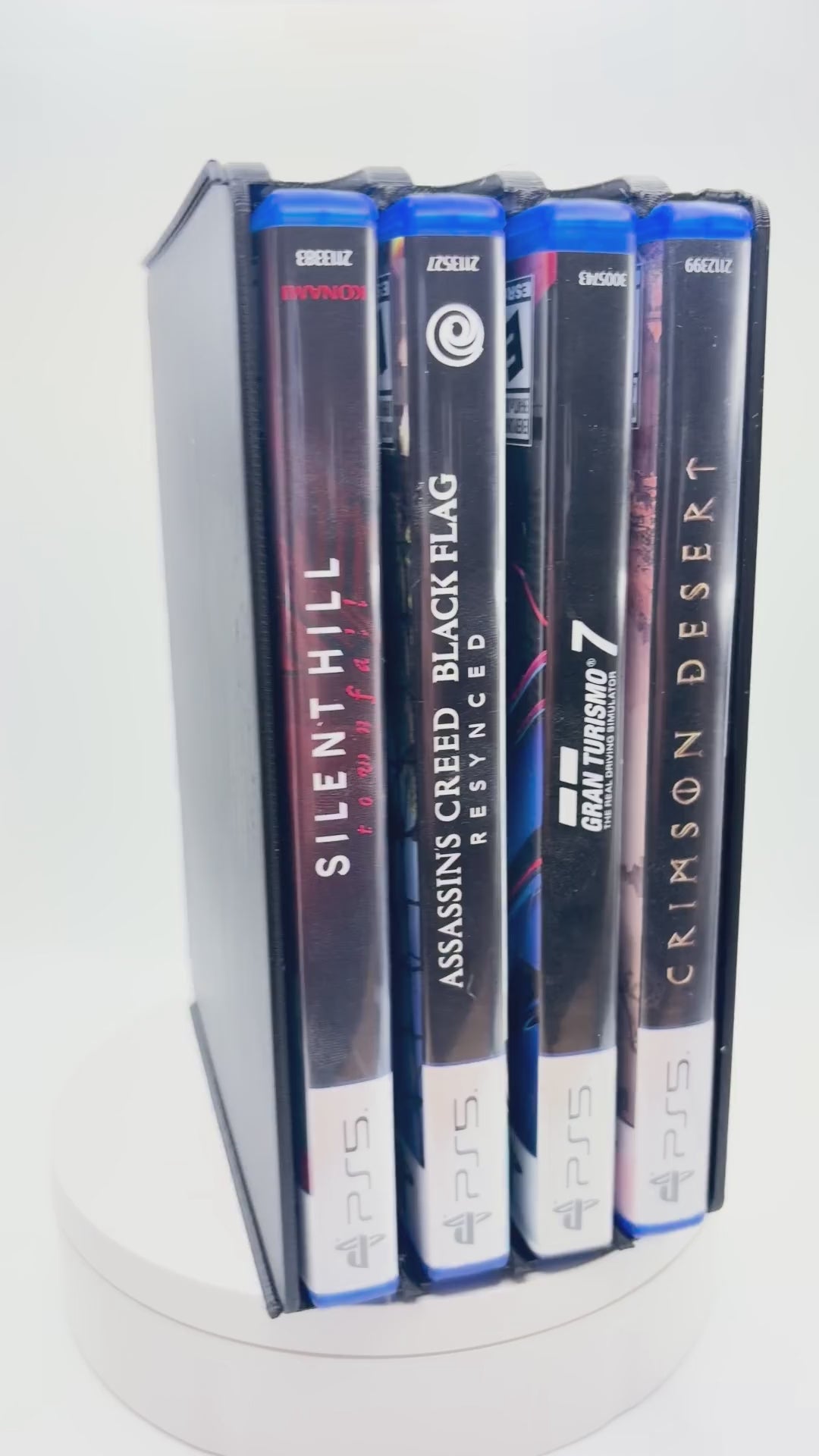 Original rotation video of the black four-slot PS5 game case holder with four cases stored horizontally.