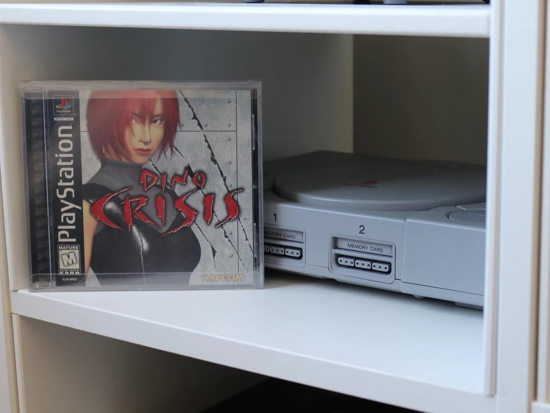 Dino Crisis and an original PlayStation on our collection shelf